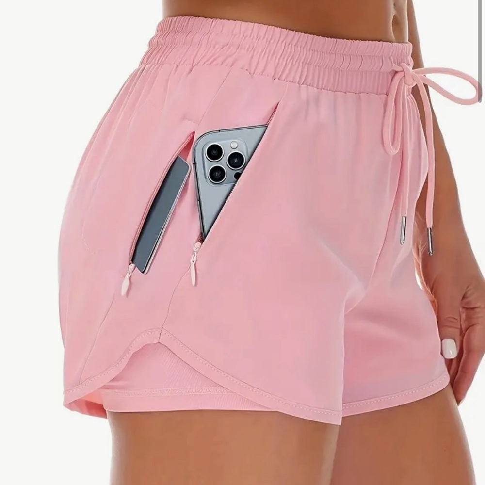 Pink 2-in-1 running shorts with zippered pockets
